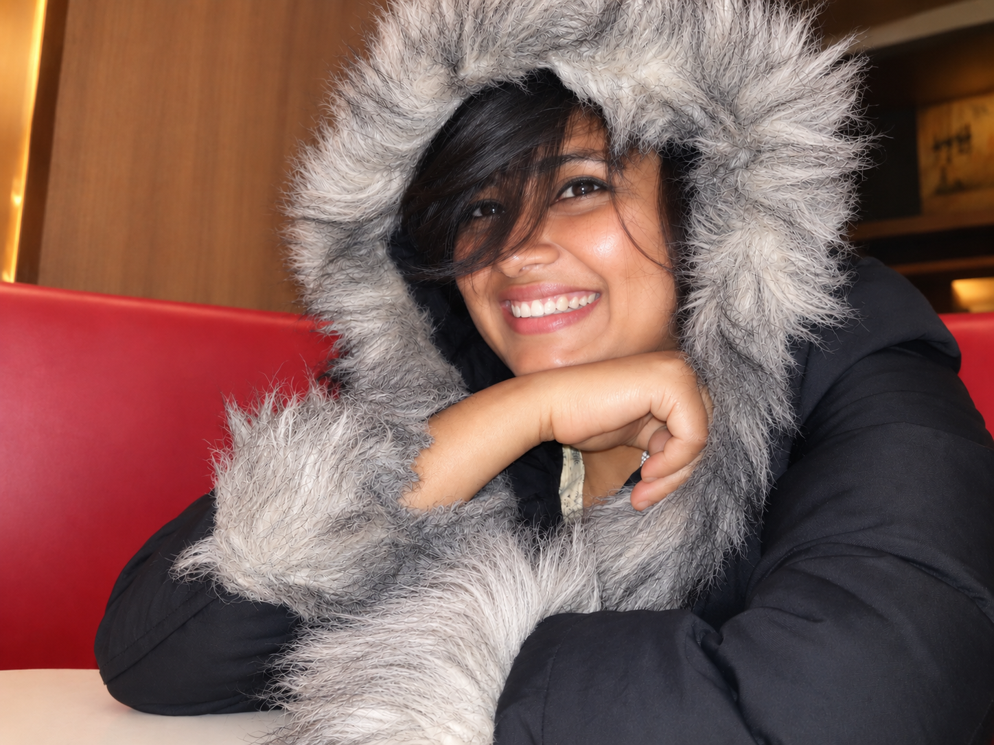 Asma Shikdar smiling in a fur-trimmed hood